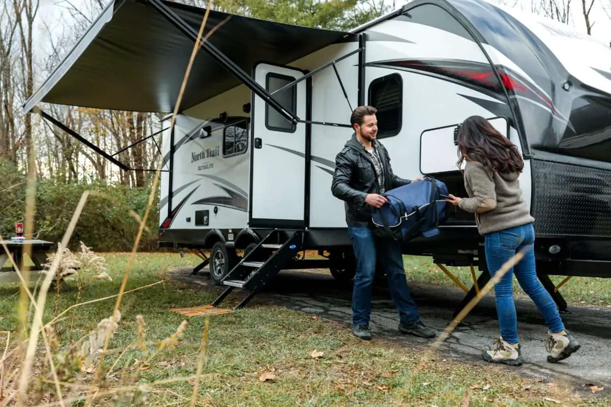 Couple setting their camp tent in an RV site