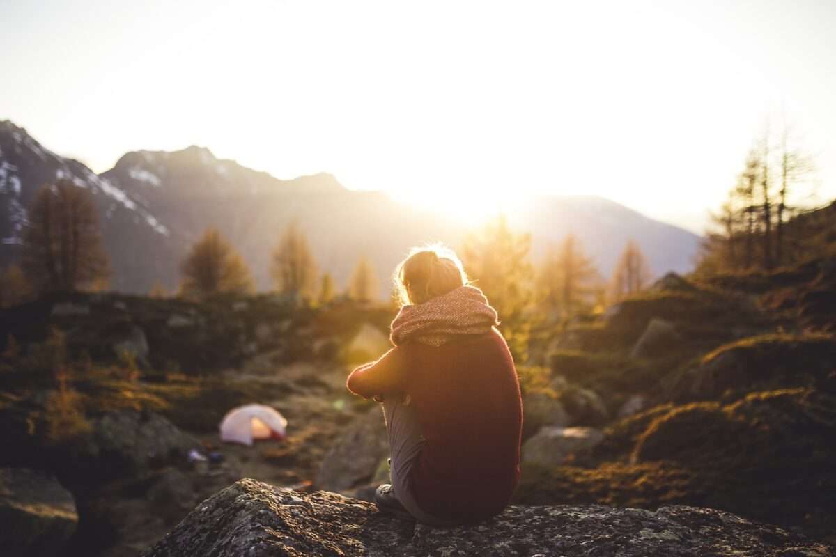 A girls sitting and thinking about the benefits of camping without a tent