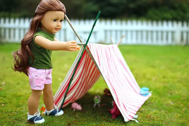 a doll standing near the tent
