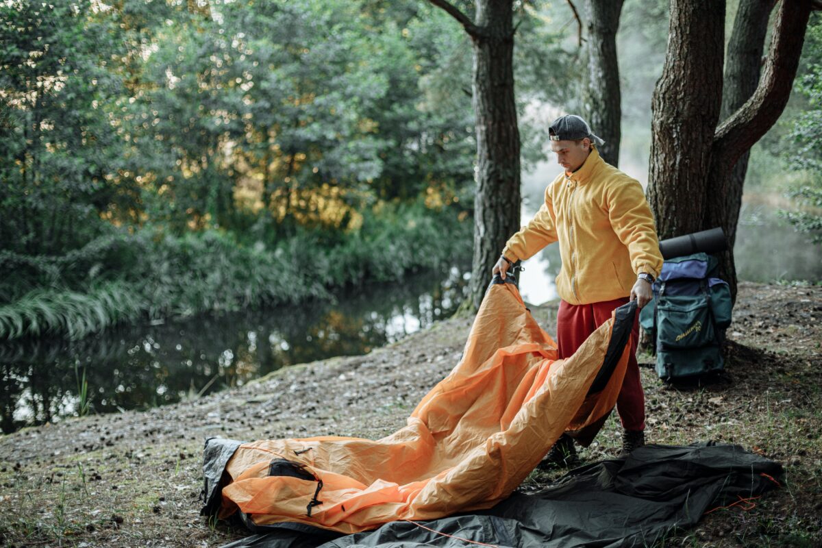 Camper boy setting up his pop up camping tent