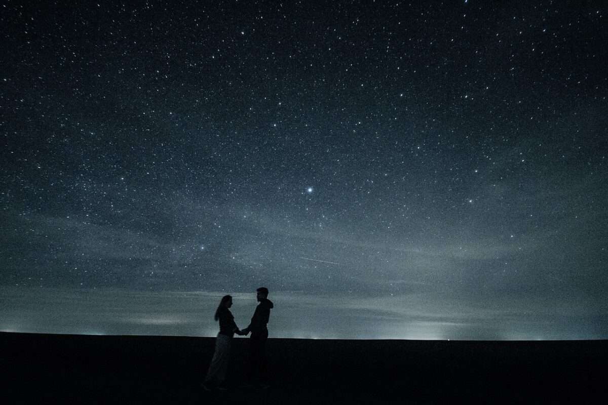 Couple camping without tent under stars