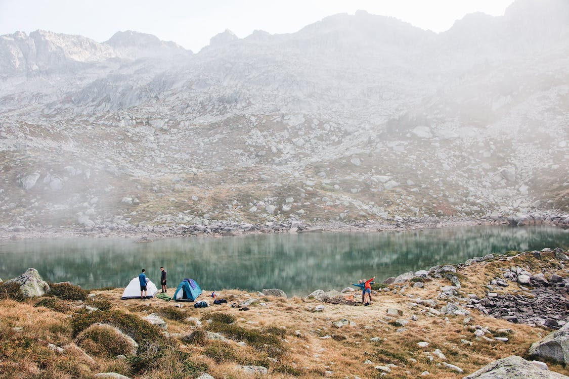 Group of people camping in rocky mountains after treeking with Lllama