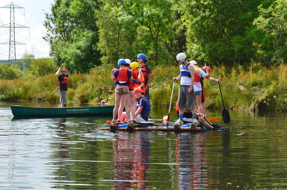 People wearing necessary gears during tent camping in a boat