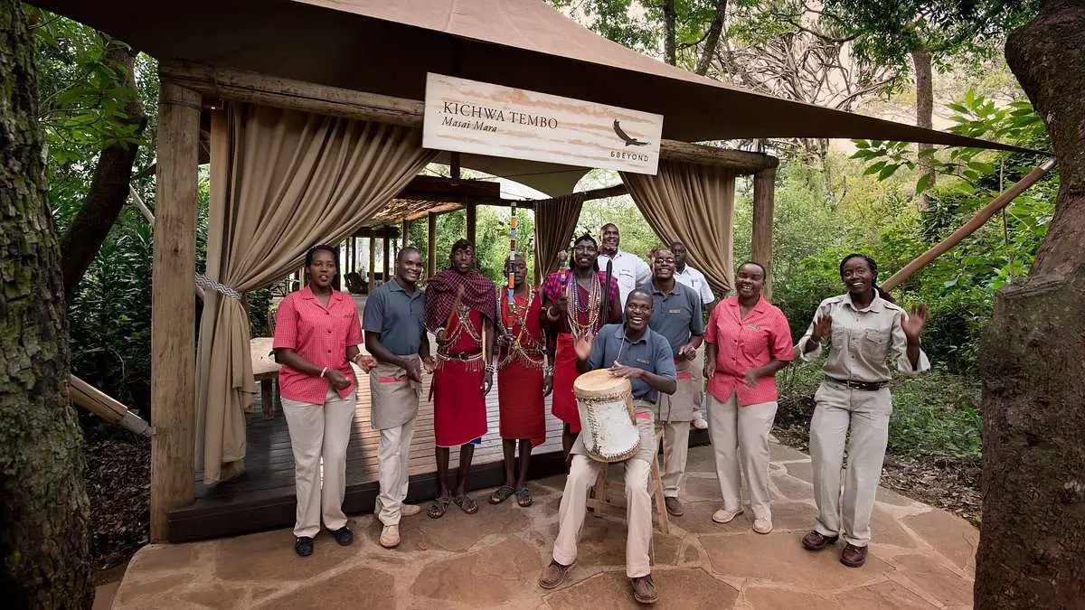 locals welcoming tourists into kichwa tented camp
