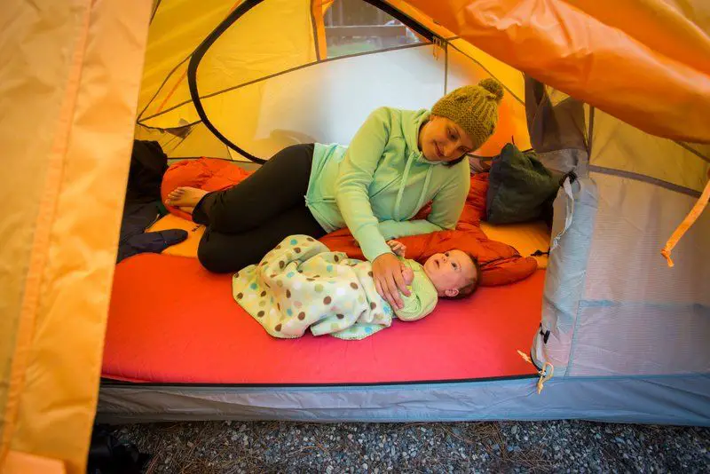 a mother with her baby in the tent