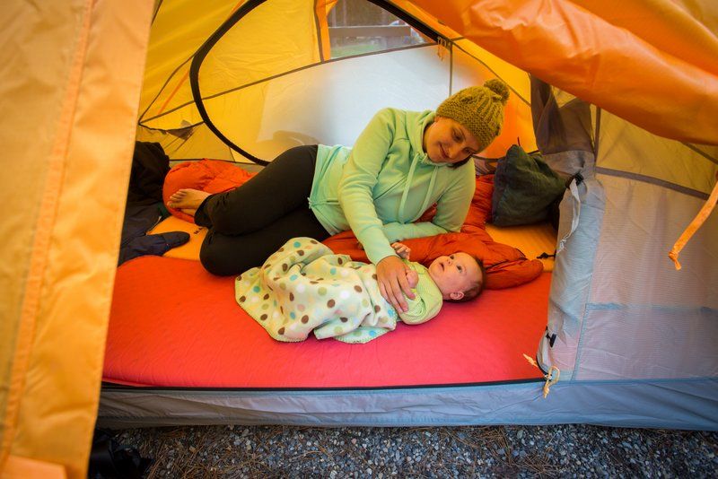 a mother with her baby in the tent