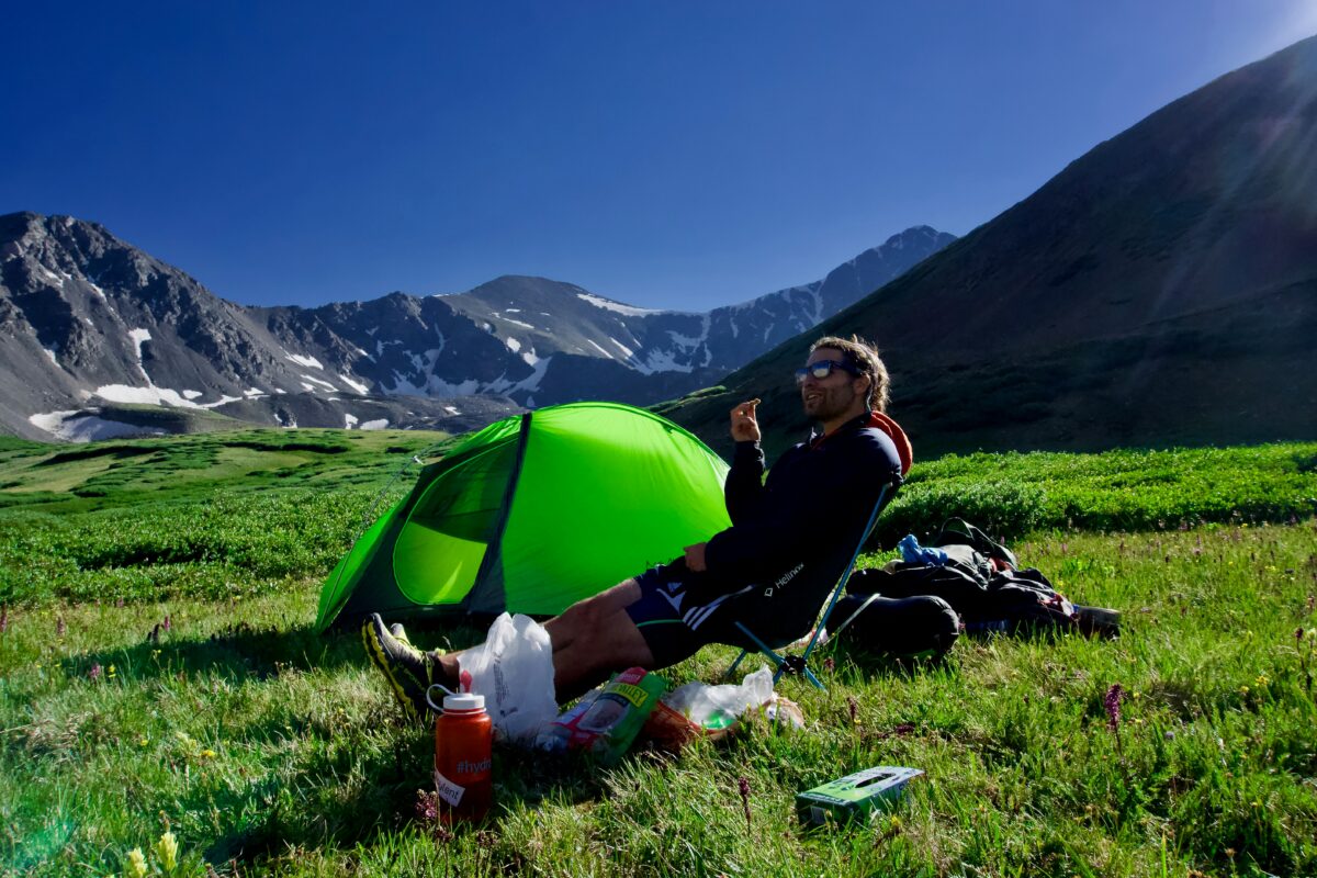 Person utilizing the windbreak in the camping 